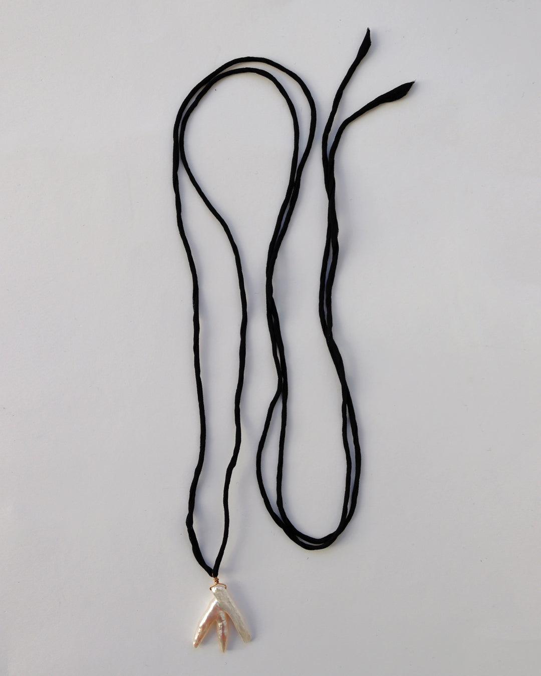 SCULPTURAL PEARL ON BLACK ROLLED SILK CORD