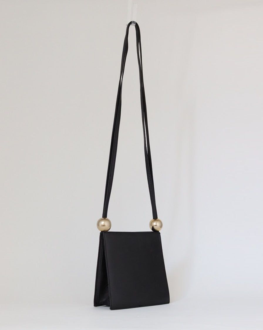 structured bag in black leather with metal spheres