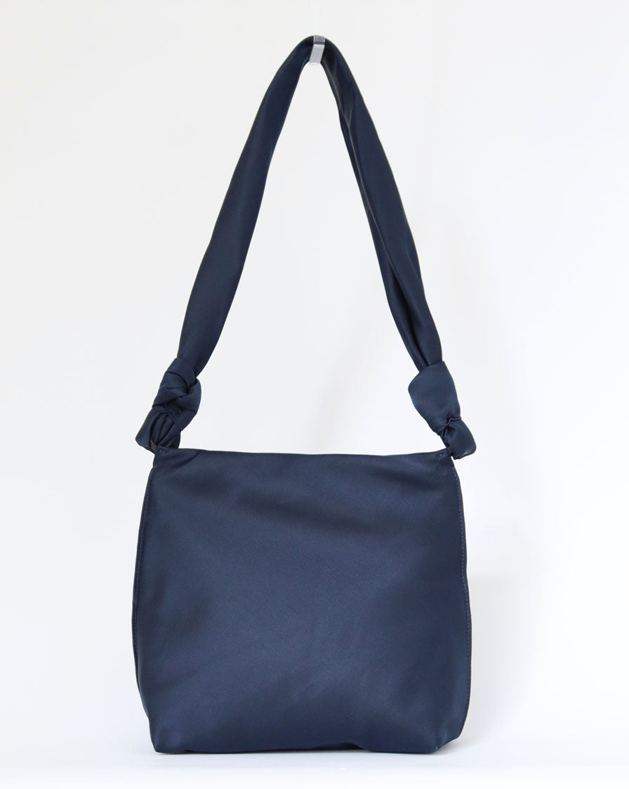 ‘Wander’ knot crossbody bag in navy blue silk