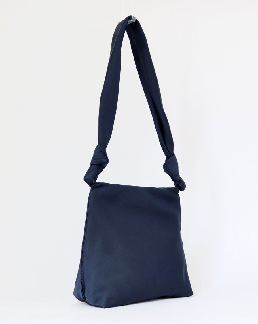 ‘Wander’ knot crossbody bag in navy blue silk