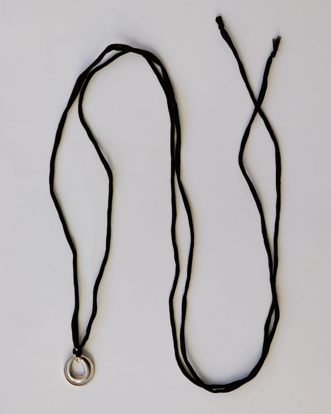 SILVER CHARM ON BLACK SILK CORD