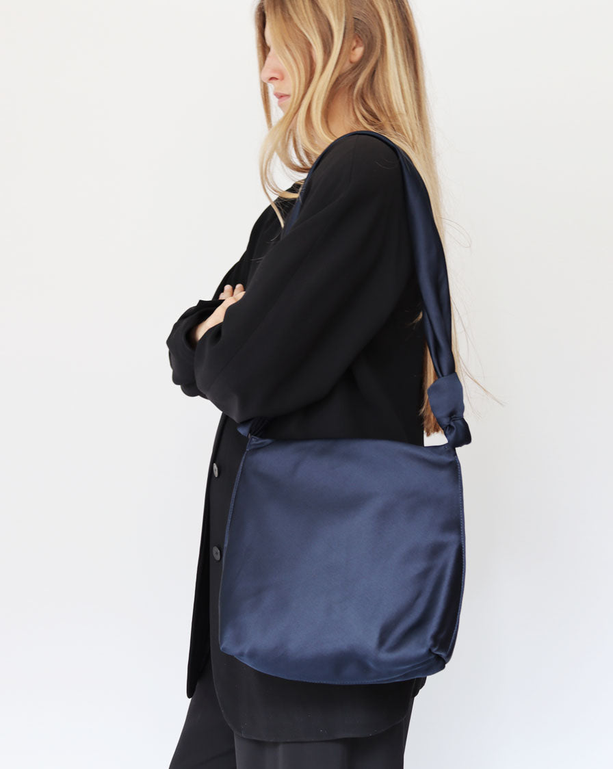 ‘Wander’ knot crossbody bag in navy blue silk