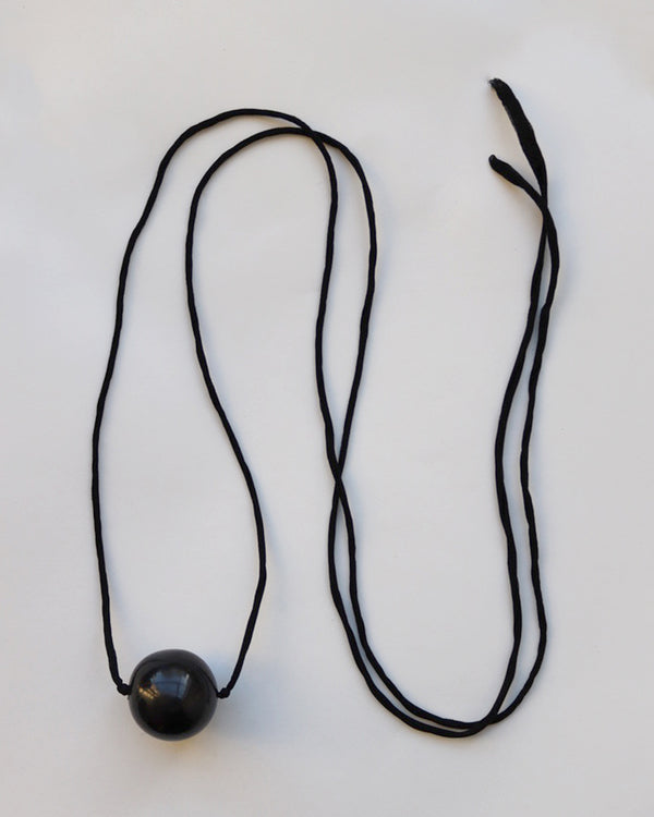 PAINTED WOOD BALL ON BLACK SILK CORD NECKLACE